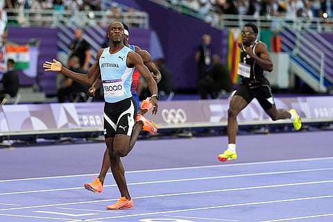Letsile Tebogo, of Botswana, celebrates after winning gold in 200-meter final